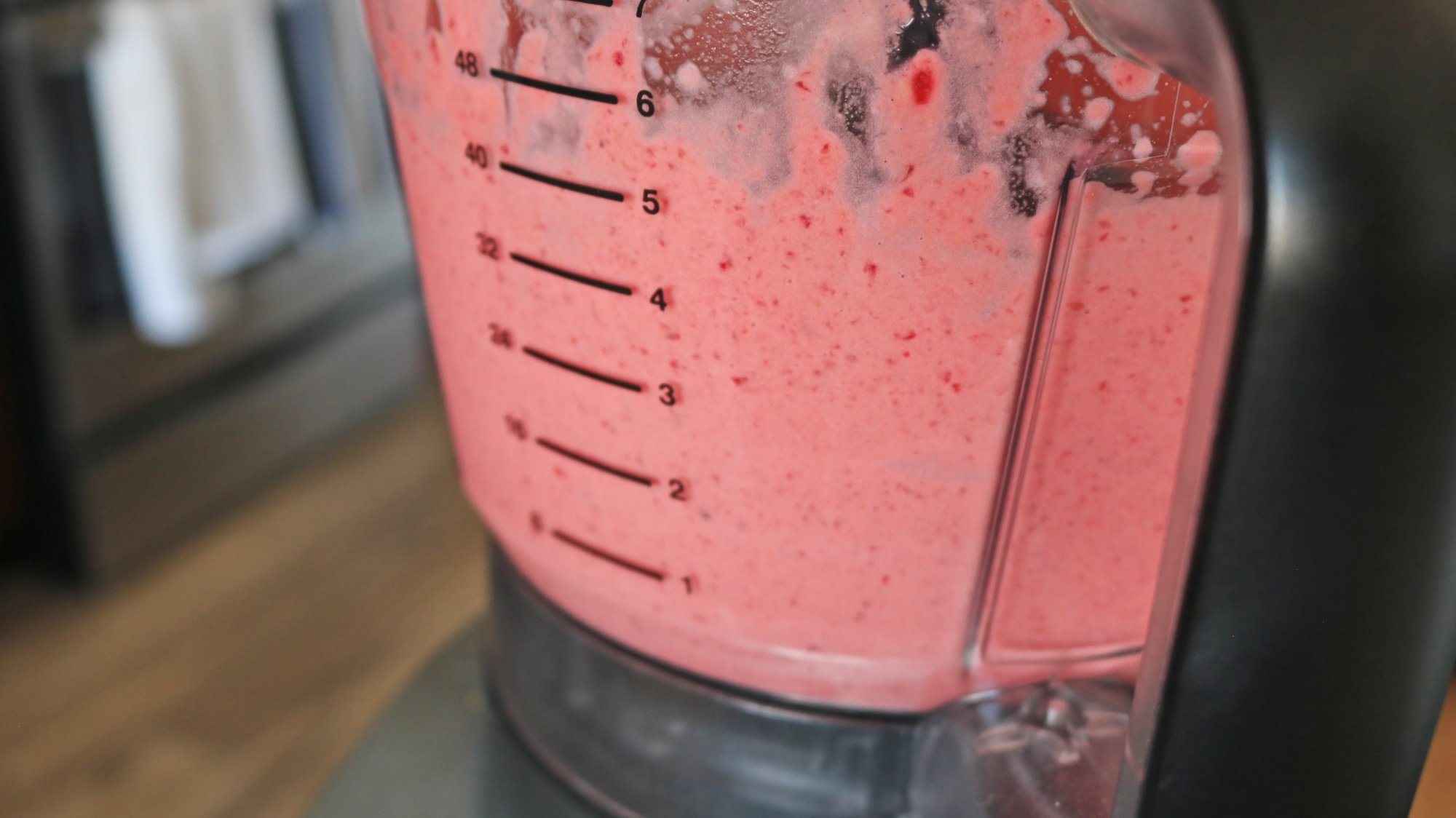 A food processor with pink dip inside