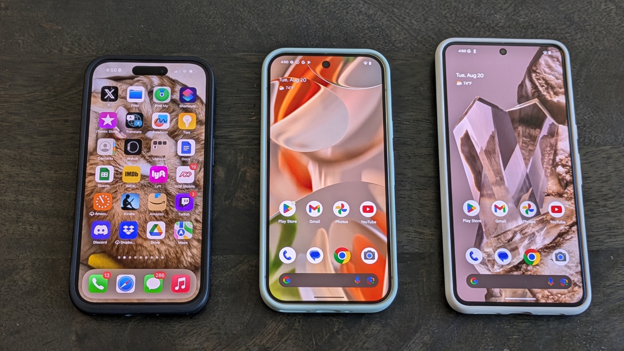 Pixel 9 Pro (middle) next to iPhone 15 Pro (left) and Pixel 8 Pro (right)