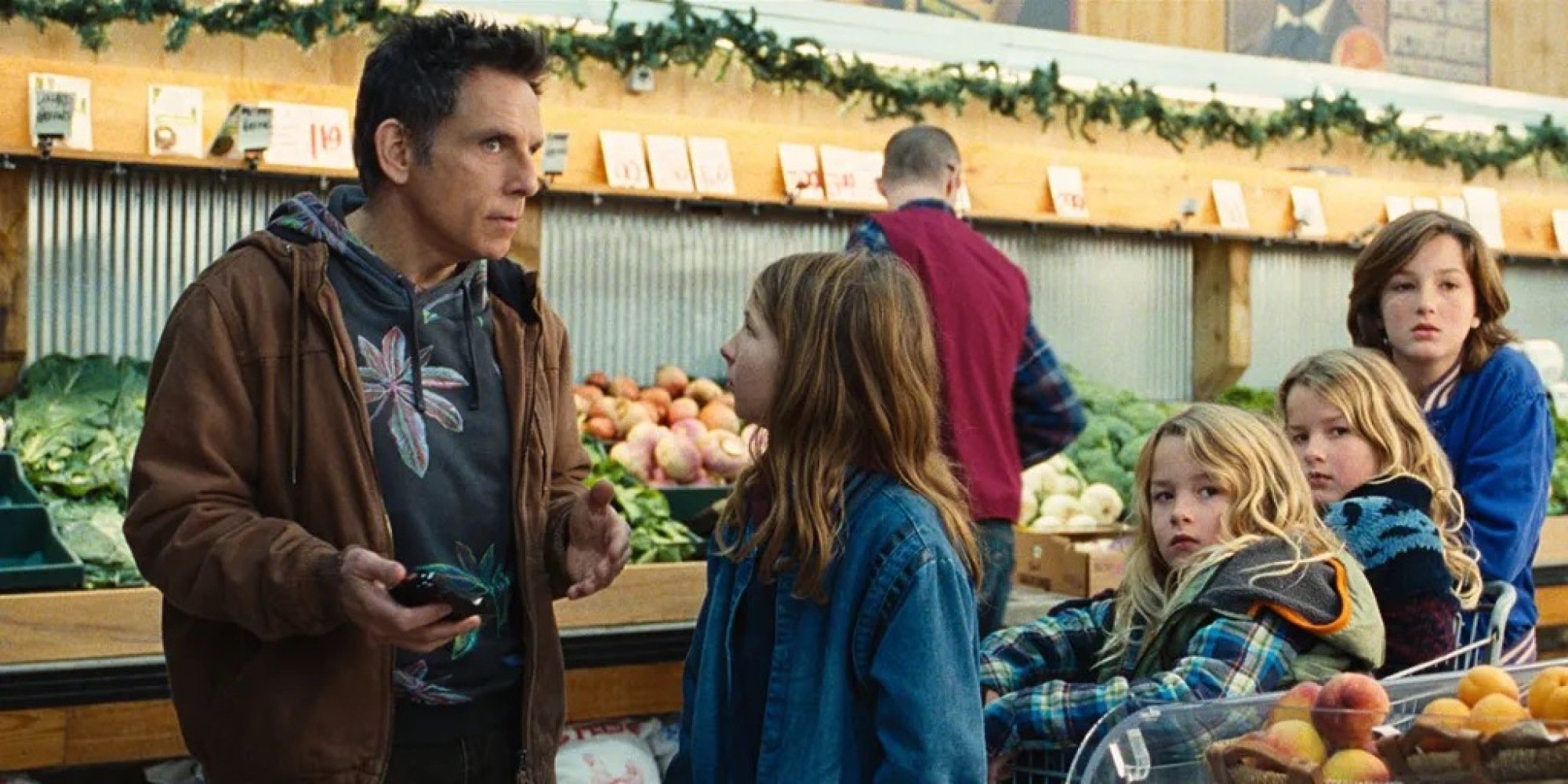 A man talks to a child in a grocery store